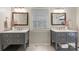 Neutral bathroom featuring double vanities with marble counters, framed mirrors, and wood-look tile floors at 1522 Barberry Ct, Charlotte, NC 28211