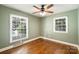 This simple bedroom features hardwood floors, neutral paint, and two windows for ample natural light at 1522 Barberry Ct, Charlotte, NC 28211