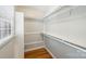 Bright, walk-in closet with custom shelving and hardwood flooring at 1522 Barberry Ct, Charlotte, NC 28211