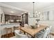 Open dining room with hardwood floors, modern lighting, and views into the kitchen at 1522 Barberry Ct, Charlotte, NC 28211