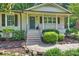 Inviting front porch with brick steps, decorative railing, and charming architectural details at 1522 Barberry Ct, Charlotte, NC 28211