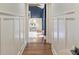 Hallway view into bedroom featuring hardwood floors, board and batten, and white trim at 1522 Barberry Ct, Charlotte, NC 28211