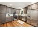 Charming kitchen with stainless steel appliances, gray cabinets, and hardwood floors at 1522 Barberry Ct, Charlotte, NC 28211