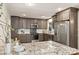 Modern kitchen features granite countertops, gray cabinets, and stainless steel appliances at 1522 Barberry Ct, Charlotte, NC 28211
