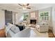 Relaxing living room features exposed brick fireplace, neutral furnishings, and hardwood floors at 1522 Barberry Ct, Charlotte, NC 28211
