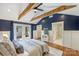 This spacious main bedroom features vaulted ceilings, exposed beams, and French doors to the backyard at 1522 Barberry Ct, Charlotte, NC 28211