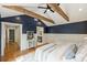Bedroom featuring hardwood floors, vaulted ceiling, exposed beams, and ensuite bath at 1522 Barberry Ct, Charlotte, NC 28211