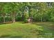 Large backyard storage shed with ample space and shade from mature trees at 1522 Barberry Ct, Charlotte, NC 28211