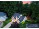 Aerial view of a well maintained home with mature landscaping, a large driveway, and lush trees at 15301 Marsh Field Ct, Huntersville, NC 28078