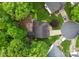 Overhead view of a home with a large deck and firepit surrounded by lush green trees in a residential neighborhood at 15301 Marsh Field Ct, Huntersville, NC 28078