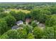 Aerial view of the home nestled among mature trees on a spacious lot in a quiet neighborhood at 15301 Marsh Field Ct, Huntersville, NC 28078