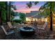 Inviting backyard with a stone fire pit and spacious deck, perfect for outdoor entertaining under string lights at 15301 Marsh Field Ct, Huntersville, NC 28078