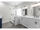Elegant bathroom with a glass-enclosed shower, double vanity, marble countertops, and modern fixtures at 15301 Marsh Field Ct, Huntersville, NC 28078