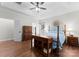 Spacious bedroom with tray ceilings, a ceiling fan, and hardwood floors at 15301 Marsh Field Ct, Huntersville, NC 28078