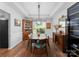Dining room with hardwood floors, modern decor, and a wine refrigerator at 15301 Marsh Field Ct, Huntersville, NC 28078