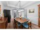 Bright dining room features a modern light fixture, wainscoting, and hardwood floors at 15301 Marsh Field Ct, Huntersville, NC 28078