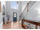 Elegant foyer with soaring ceilings, hardwood floors, staircase and a stylish entryway at 15301 Marsh Field Ct, Huntersville, NC 28078