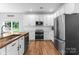 Bright kitchen featuring white cabinets, stainless steel appliances, and a wood-topped island at 15301 Marsh Field Ct, Huntersville, NC 28078