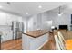 Open concept living room and kitchen with stainless steel appliances and hardwood floors at 15301 Marsh Field Ct, Huntersville, NC 28078