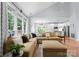 Open concept living room featuring a large sectional, hardwood floors and ample natural light at 15301 Marsh Field Ct, Huntersville, NC 28078