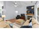 Cozy living room showcasing hardwood floors, a ceiling fan and a corner fireplace at 15301 Marsh Field Ct, Huntersville, NC 28078