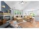 Inviting living room with fireplace, hardwood floors, and an open view to the kitchen at 15301 Marsh Field Ct, Huntersville, NC 28078