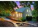 Charming two-story home featuring a screened porch, deck and professionally landscaped backyard at twilight at 15301 Marsh Field Ct, Huntersville, NC 28078