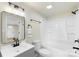 Bathroom with white tiled shower, modern vanity, and neutral walls at 1574 Mangum Dr, Lancaster, SC 29720