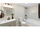 Bathroom with white tiled shower, modern vanity, and neutral walls at 1574 Mangum Dr, Lancaster, SC 29720