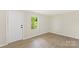 Bedroom featuring wood-look flooring, neutral paint, an updated window, and modern fixtures at 1574 Mangum Dr, Lancaster, SC 29720