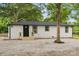 Ranch home with gravel yard, newly refinished siding, black trim, and inviting front entrance at 1574 Mangum Dr, Lancaster, SC 29720