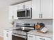 Close up kitchen featuring modern stainless steel appliances, white cabinets, and stone countertops at 1574 Mangum Dr, Lancaster, SC 29720