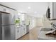 Kitchen with stainless appliances, white cabinets, light countertops, and wood flooring at 1574 Mangum Dr, Lancaster, SC 29720