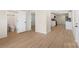 Open-concept living space with a view into the kitchen and a glimpse of the renovated bathroom at 1574 Mangum Dr, Lancaster, SC 29720