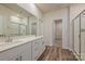 A primary bathroom features double sinks, standing shower, and a walk-in closet at 1600 Baymont Ct, Stanley, NC 28164