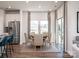 Dining area with a modern table set, stylish chairs, and large windows offering natural light, adjacent to kitchen at 1600 Baymont Ct, Stanley, NC 28164