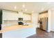 Bright kitchen featuring an island with sink, stainless steel appliances, and white cabinetry at 1600 Baymont Ct, Stanley, NC 28164
