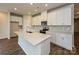 Bright kitchen features white cabinets, an island with sink, stainless steel appliances, and a modern backsplash at 1600 Baymont Ct, Stanley, NC 28164