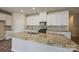 Island has granite countertops, stainless steel appliances, and white cabinets at 1600 Baymont Ct, Stanley, NC 28164