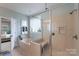 Well-lit bathroom features a glass-enclosed shower, soaking tub, and access to the main bedroom at 1643 Essex Hall Dr, Rock Hill, SC 29730