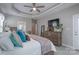 Well-lit main bedroom features a tray ceiling, dresser, and a doorway leading to other parts of the home at 1643 Essex Hall Dr, Rock Hill, SC 29730