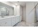 Bathroom with double sink vanity, mirror, and glass door shower at 17812 New Mark Ave, Charlotte, NC 28278