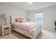 Inviting bedroom featuring a bright, white bed frame and coordinating side table, illuminated by two elegant lamps at 17812 New Mark Ave, Charlotte, NC 28278