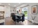 Elegant dining room with a modern table, leather chairs, and sliding glass doors at 17812 New Mark Ave, Charlotte, NC 28278