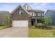 Charming two-story home with brick and siding, a well-kept lawn, and a two-car garage at 17812 New Mark Ave, Charlotte, NC 28278
