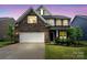 Beautiful two-story home with brick and siding, lush lawn, and two-car garage at 17812 New Mark Ave, Charlotte, NC 28278