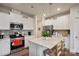 Stylish kitchen featuring stainless steel appliances, white cabinets, and an island with seating at 17812 New Mark Ave, Charlotte, NC 28278