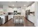 Bright kitchen with stainless appliances, white cabinets, and center island with seating at 17812 New Mark Ave, Charlotte, NC 28278