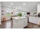 Bright open kitchen boasts an island, stainless appliances, and eat-in area with views of the outdoors at 17812 New Mark Ave, Charlotte, NC 28278