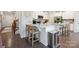 Modern kitchen with white cabinets, stainless steel appliances, and an island with bar stools at 17812 New Mark Ave, Charlotte, NC 28278